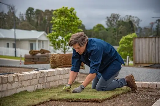 man laying turf